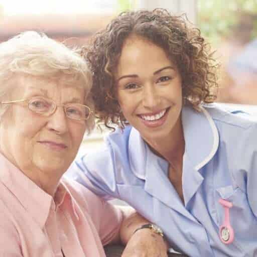 Caregiver and Elderly Woman Smiling Together